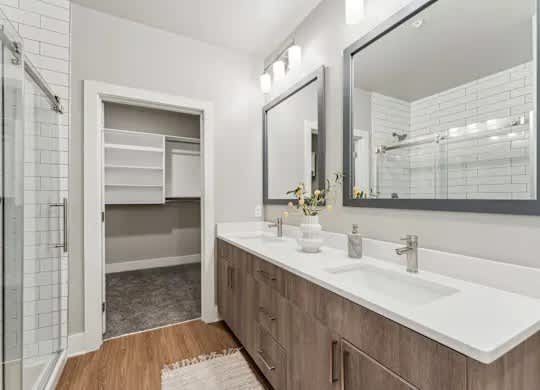 A bathroom with a white sink and a mirror.