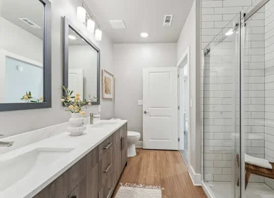 A bathroom with a white sink and a mirror.