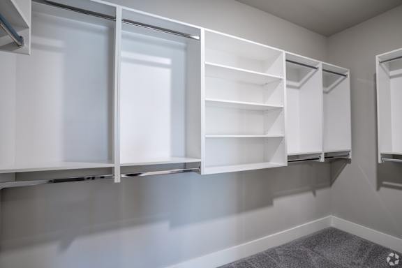 A white pantry with shelves and cabinets.at The Delaney at East Park Apartments, Kennesaw, GA, 30144