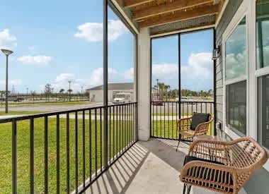A balcony with a chair and a table.