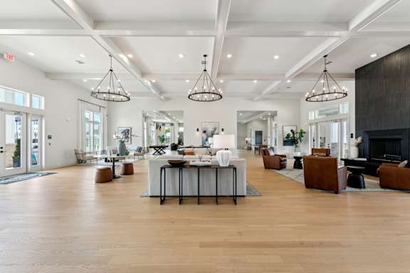 A spacious living room with a dining table in the center at The Hendry Apartments, Fort Myers, FL, 33905