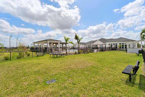 A park with a pavilion, benches, and a fence at The Hendry Apartments, Florida, 33905