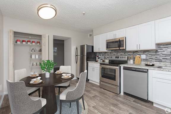 A Kitchen With Dining Table at Avondale Place Apartments, Georgia