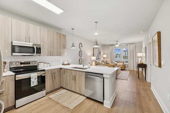 Floor Plan  A modern kitchen with wooden cabinets and stainless steel appliances.