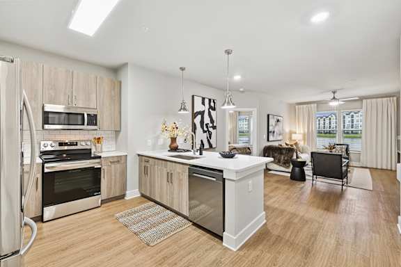 Floor Plan  A modern kitchen with wooden cabinets and stainless steel appliances.