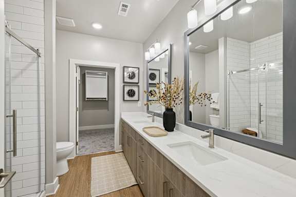 A bathroom with a white sink and a mirror.