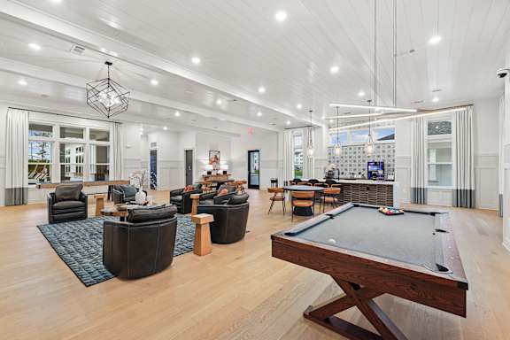 A billiard table is in the middle of a spacious room with a pool table at The Beacon at 331 Apartments, Santa Rosa Beach, FL