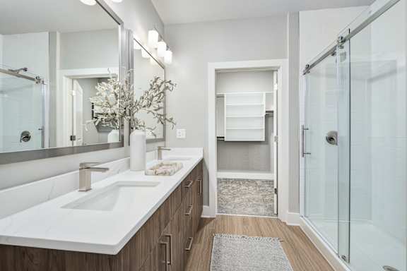 A bathroom with a white sink and a glass shower.at The Ashton at East Park Apartments, Kennesaw, GA, 30144