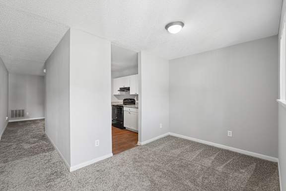 A kitchen area with a dishwasher and a refrigerator.