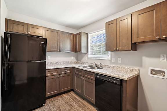 Kitchen with brown cabinets at Lexington on the Green, Raleigh, North Carolina