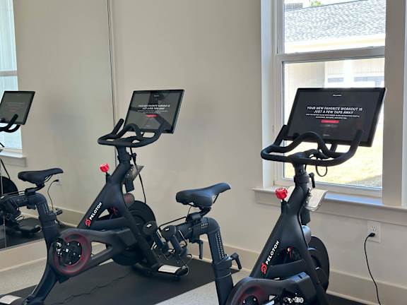 Three stationary bikes are lined up in a room at The Beacon at 331 Apartments, Santa Rosa Beach, FL