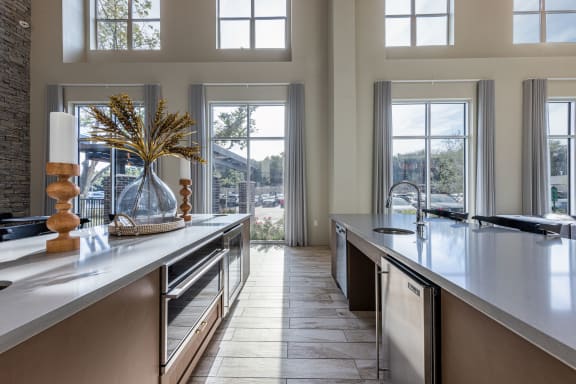 a large kitchen with large windows and a large counter top