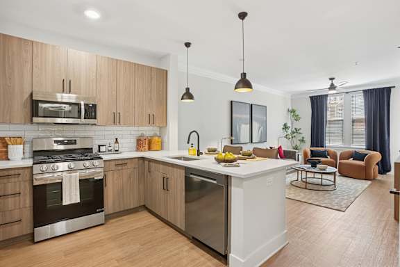 Floor Plan  A modern kitchen with wooden cabinets and stainless steel appliances at Union Eleven Apartments, Georgia