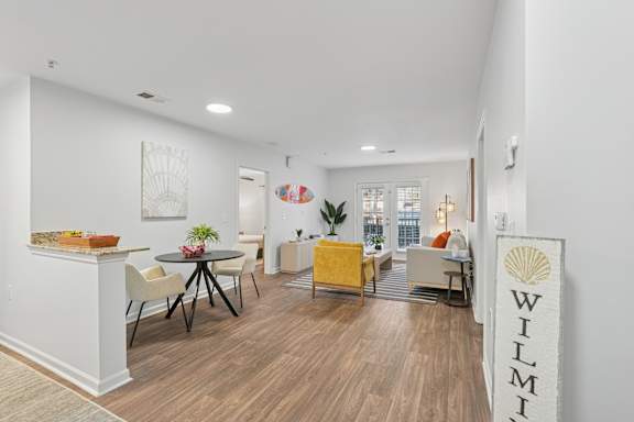 A living room with a wooden floor and furniture.