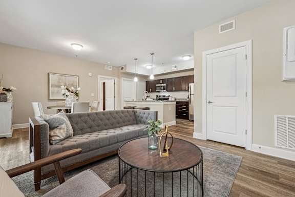 A living room with a grey couch and a coffee table.