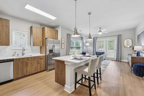 A modern kitchen with a dining table and chairs.