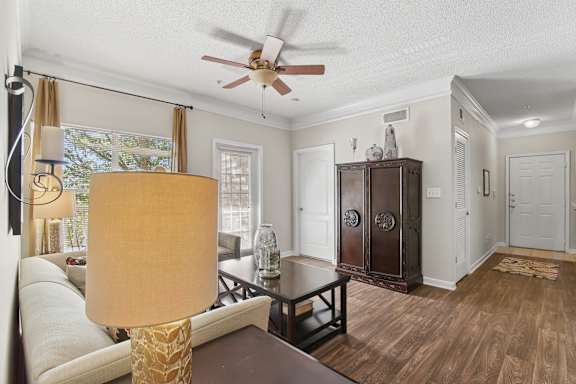 A living room with a brown table and a white sofa.