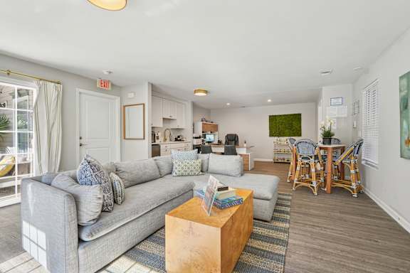 A living room with a grey couch and a wooden coffee table.