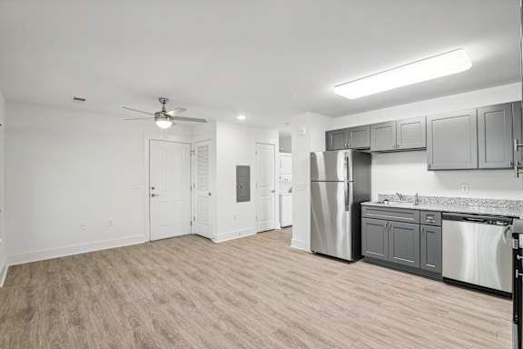 A kitchen with a refrigerator, dishwasher, and oven at The Parker North Augusta, North Augusta, SC, 29841