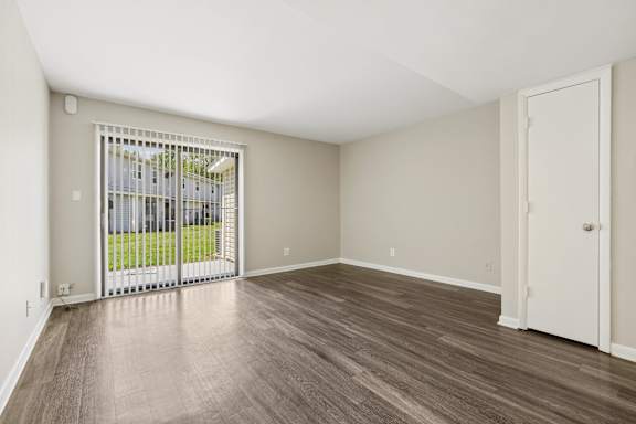 A room with a sliding door leading to a balcony.