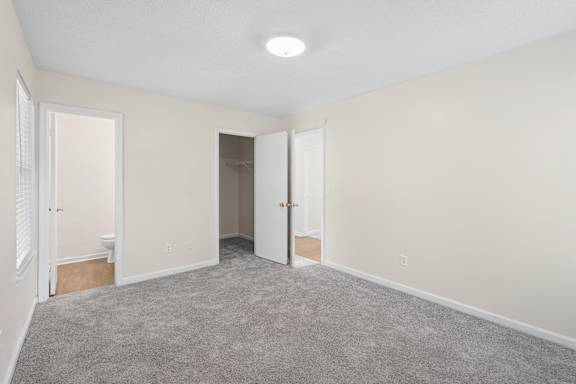A room with carpeted floor and white walls.