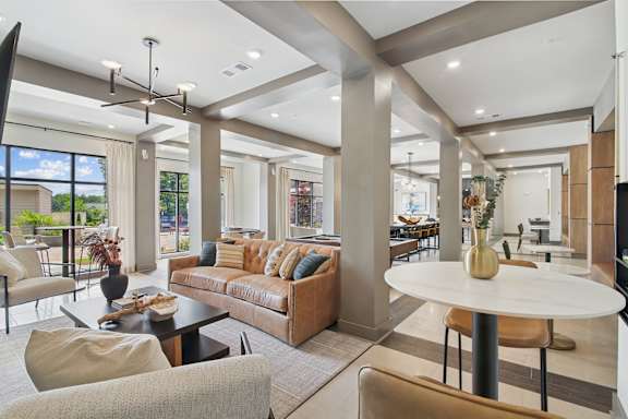 A modern living room with a large couch and a coffee table.