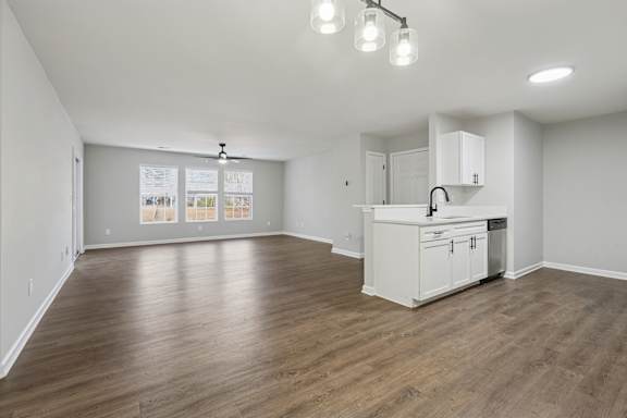 A kitchen area with a white cabinet and a fridge.