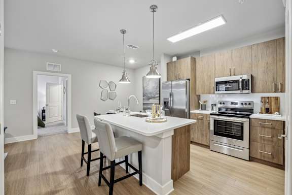 A modern kitchen with a dining table and chairs.
