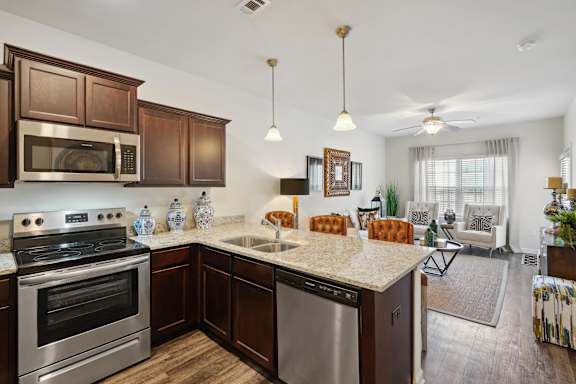 a kitchen with stainless steel appliances and a granite counter top