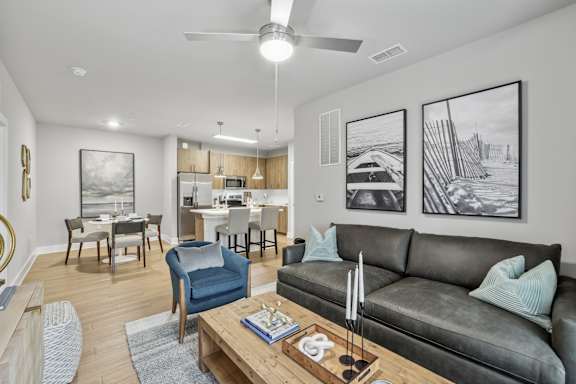 A living room with a grey couch and a coffee table.