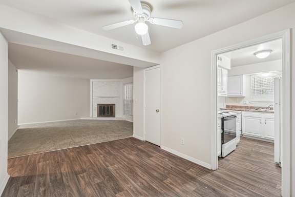 A room with a fireplace and a ceiling fan.