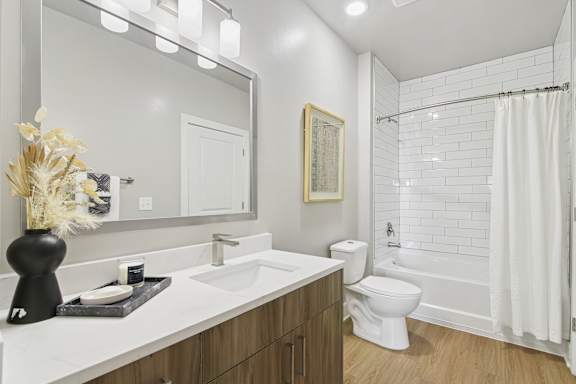 A bathroom with a white sink and a white toilet.