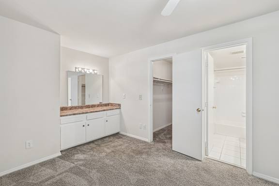 A room with a vanity and a mirror.