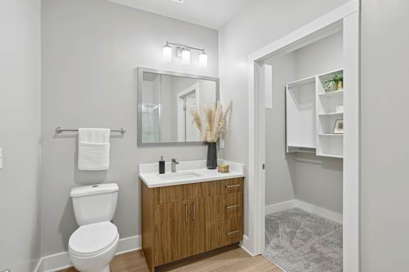 A white toilet sits next to a sink in a bathroom.