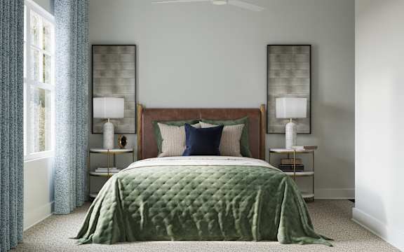 A bed with a green comforter is in the center at The SoHo Luxury Apartments, Raleigh, NC 27603