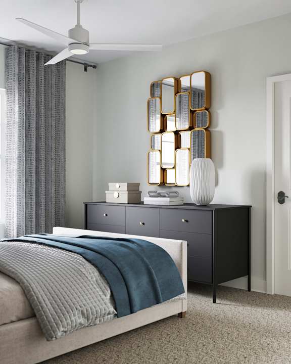A bedroom with a bed, dresser at The SoHo Luxury Apartments, Raleigh, 27603