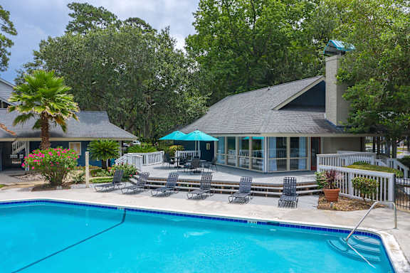 a swimming pool in front of a house with a pool at West Wind Landing, Savannah, GA, 31410