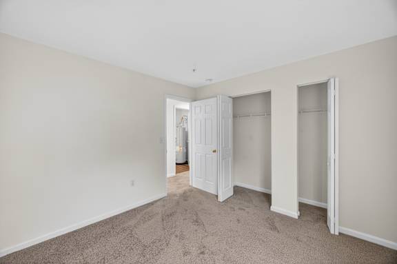 A room with a carpeted floor and white walls.