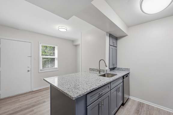 A kitchen with a granite countertop and a sink.