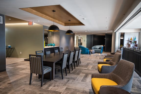 a long dining room with chairs and a table
