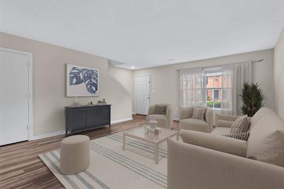 A living room with a large painting on the wall and a wooden floor.