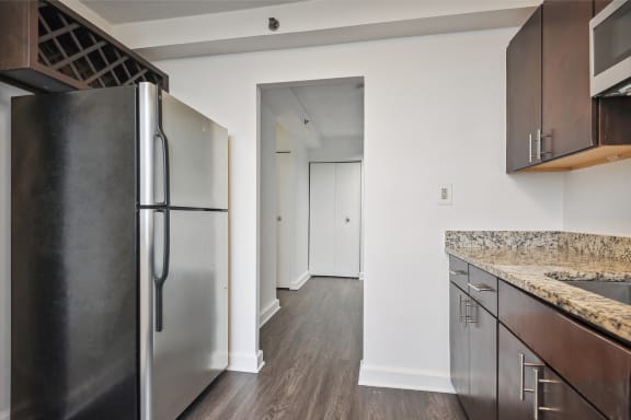 an empty kitchen with stainless steel appliances and granite counter tops