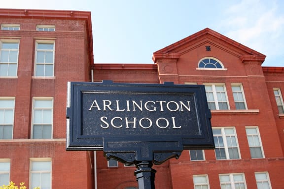a sign in front of a brick building