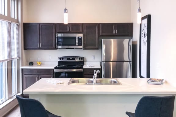 a kitchen with stainless steel appliances and a white counter top at Art Lofts at Dayton Arcade apartments in Dayton, OH