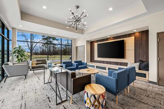 A modern living room with a large window and a flat screen TV.