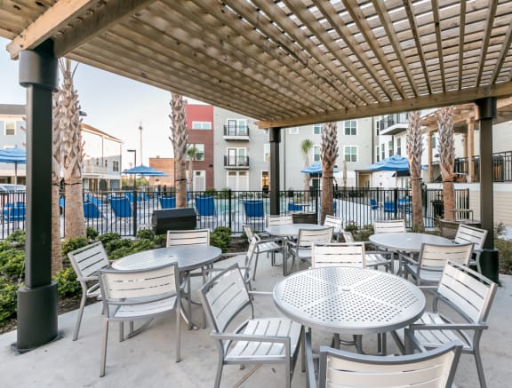 BBQ and outdoor dining area outside the pool deck at Cedars at Carver Park Apartments