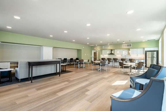 A room with a long table and chairs.