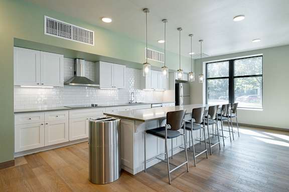 A modern kitchen with white cabinets and a large island.