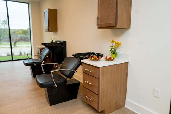 A modern kitchen with black appliances and wooden cabinets.