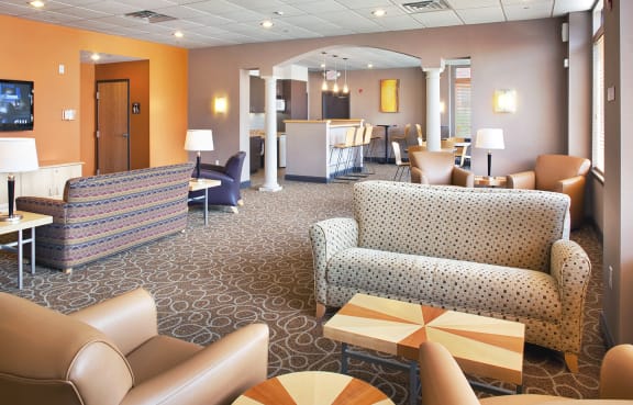 a lobby with couches and chairs and a reception desk at Fairfield Apartments and Townhomes in Pittsburgh, PA